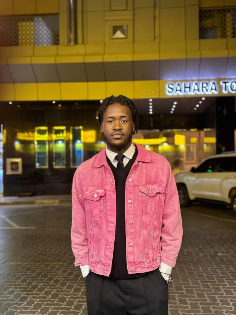 Mr. DURBA in a pink jacket in a Dubai street portrait