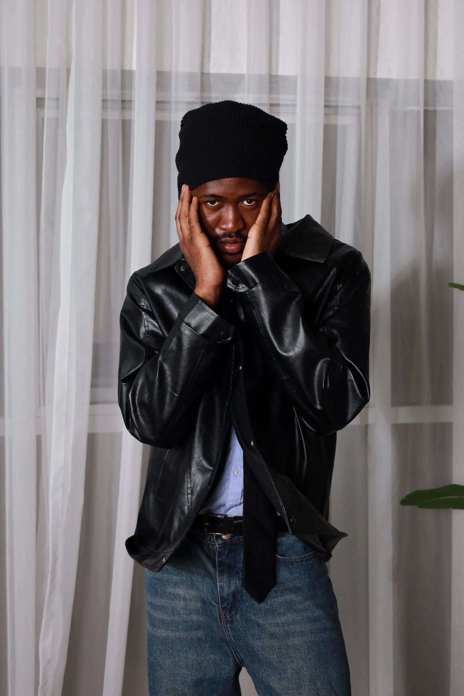 Fashion portrait of Mr. DURBA in a black jacket, looking into the camera