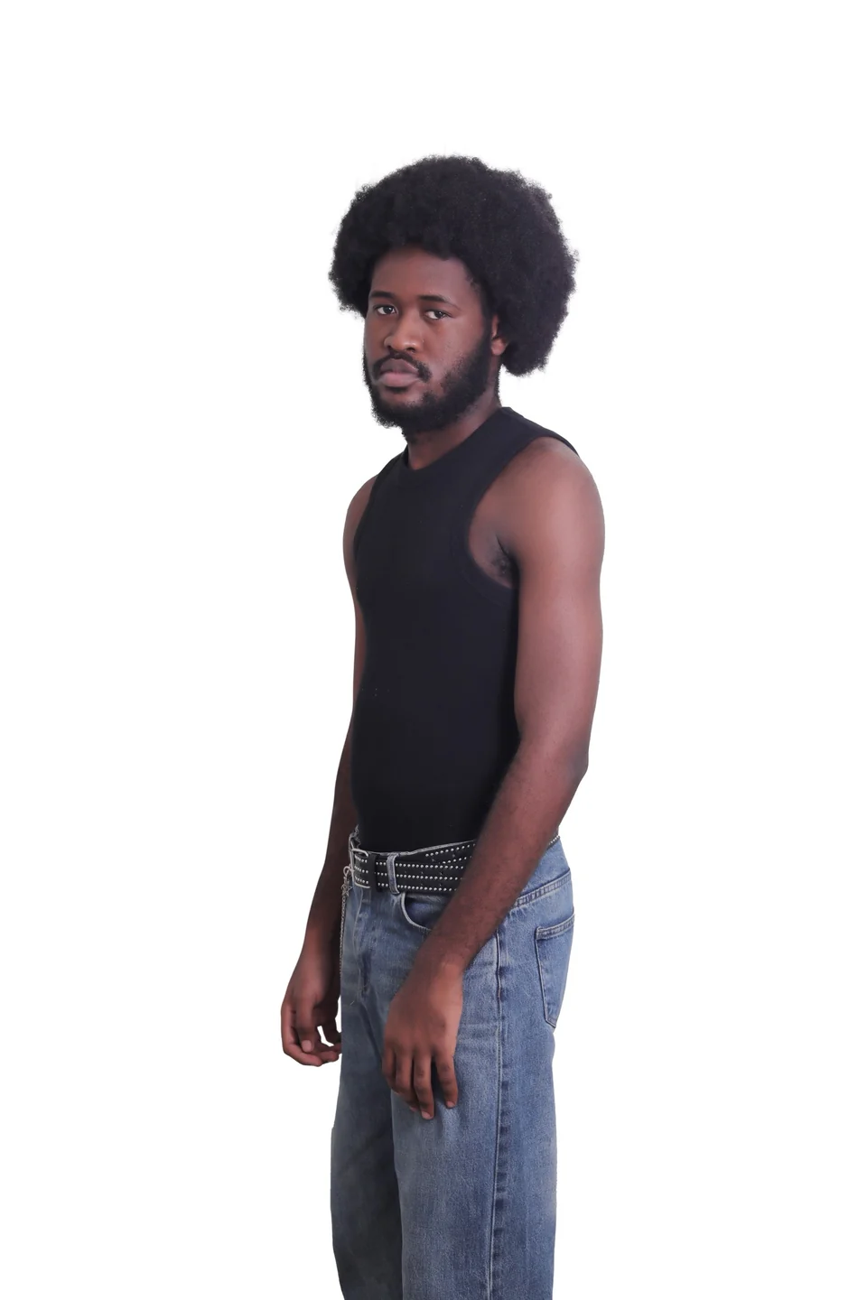 Three-quarter studio portrait of Mr. DURBA in a black top and jeans