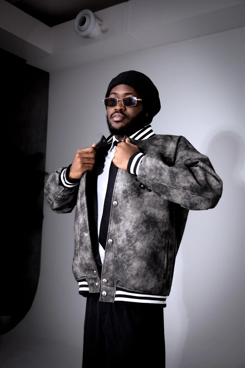 Streetwear portrait of Mr. DURBA in glasses and a textured jacket